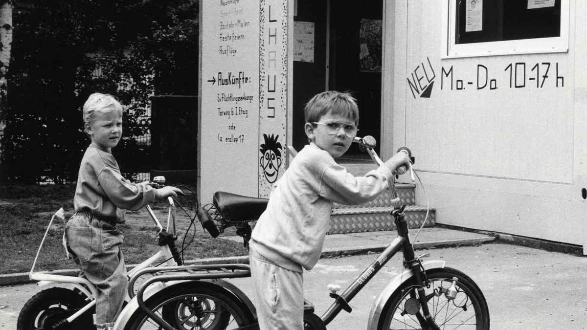 Two boys on bicycles in front of Troll House