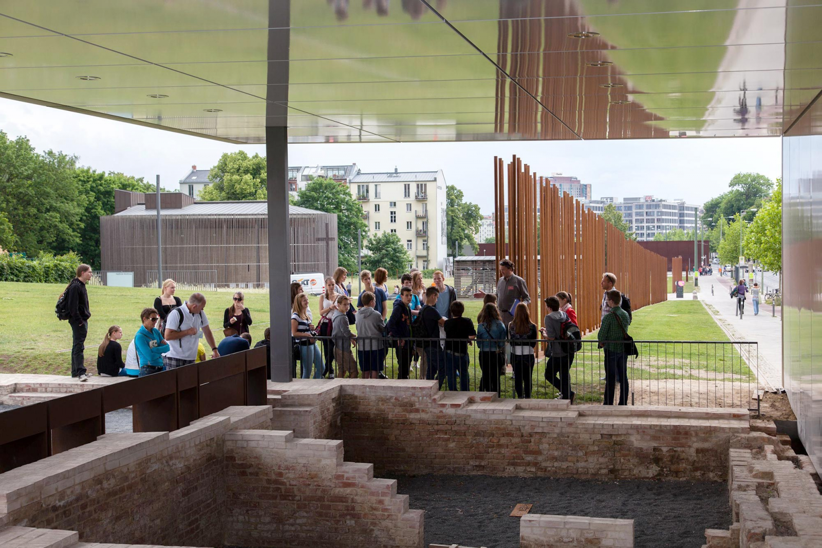 A group of schoolchildren in front of the ruins at the Grenzhaus, the Berlin Wall Memorial